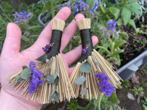 pic 14 both brooms outside flower background